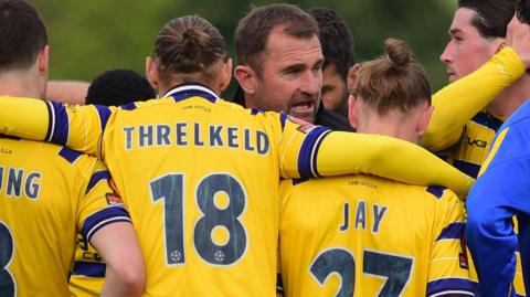 Paul Wotton conducts a team talk with his Torquay squad