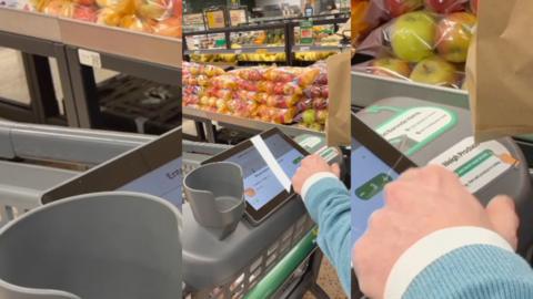 A shopping trolley with a small computer screen attached to the handle bar.