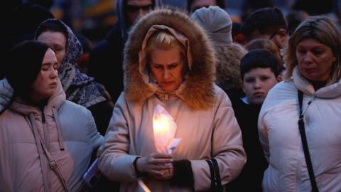 Mourners at memorial to shooting attack victims in Moscow region