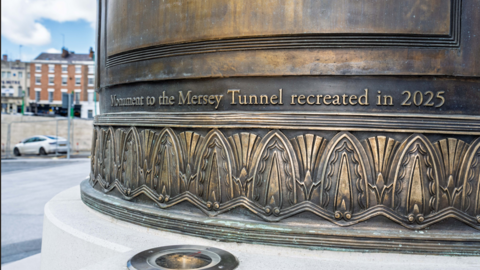 Image shows a reinforced concrete cylindrical monument on a plinth. It has been highly polished to resemble the original granite. Visible are the words "Monument to the Mersey tunnel recreated in 2025". 