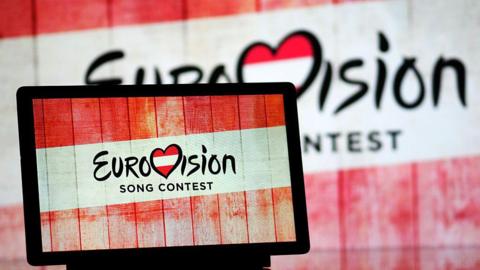 Eurovision Song Contest 2026 in Austria logo is seen displayed on a tablet. 
