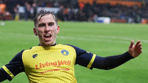 Joe Sbarra slides on his knees as he celebrates a goal for Solihull