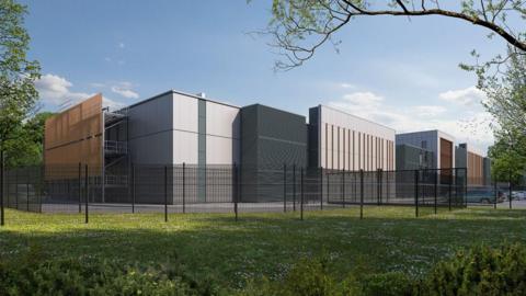 A computer-generated image of a large data centre with high fencing and a field in front of it. The building is made out of a series of blocks and appears to have few windows. It is mostly dark grey, light grey and brown.