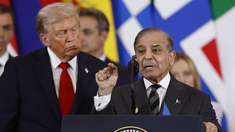 US President Donald Trump (C) listens to Pakistan's Prime Minister Shehbaz Sharif (R) as he delivers a statement during a summit on Gaza in Sharm el-Sheikh on October 13, 2025