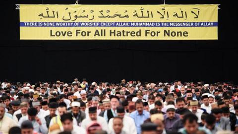Members of the Ahmadiyya Muslim community are led in prayer