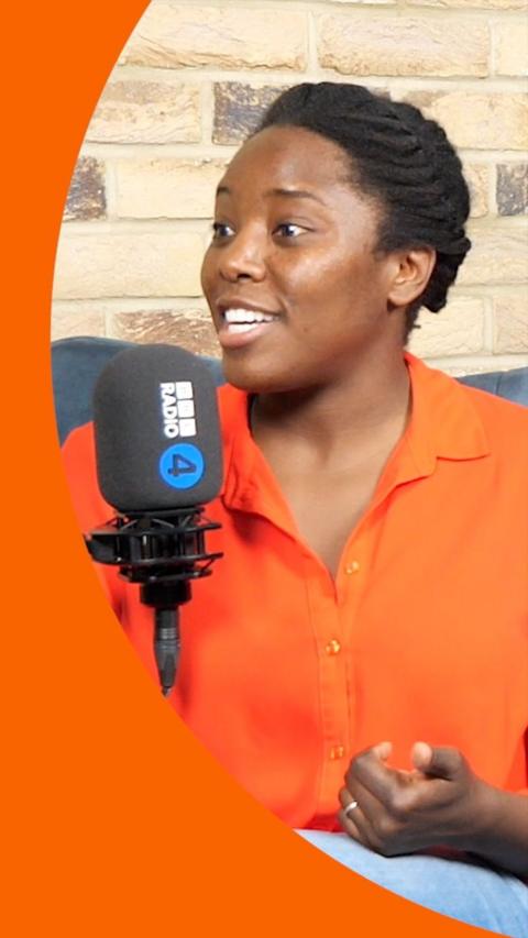 A woman in an orange shirt talking into a Radio 4 branded microphone
