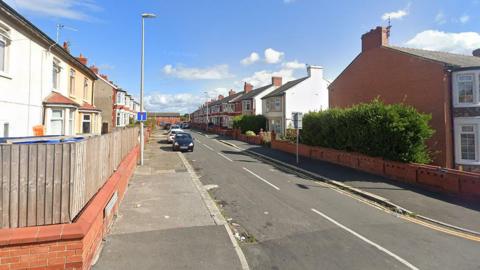 Chesterfield Road in Blackpool - a residential street with semi-detached houses on each side. There are some cars parked on the pavement.