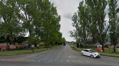 Entrance to industrial estate showing signs for various companies