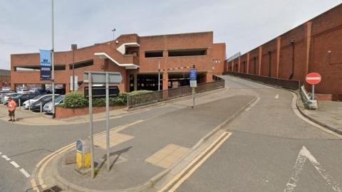 The Wharf Road multi-storey car park in Grantham. The red-brick car park is on three levels. The picture shows the entry and exit ramp to the car park. 