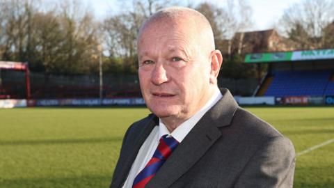 New Aldershot Town owner Deane Wood in suit & club tie
