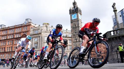 Ally Wollaston of team Suez (centre left) passes the Tolbooth Steeple during stage four of the 2025 Lloyds Tour of Britain Women in Glasgow