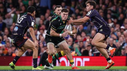 Tommy Freeman, ball in hand, is approached by two opponents from Union Bordeaux Begles during Northampton's defeat in the Champions Cup.