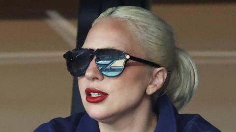 Lady Gaga wearing black sunglasses and a navy top at an Olympic gymnastics qualifying session 