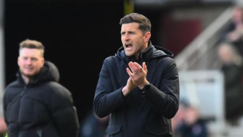 Portsmouth manager John Mousinho applauds his players from the touchline at Middlesbrough.