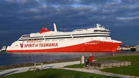 A large red and white ship with Spirit of Tasmania written on the side