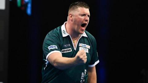 Daryl Gurney clenches his fist in delight as he wins the World Cup of Darts for Northern Ireland