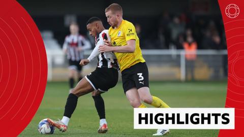 Junior Mondial of Spennymoor Town competes with Lewis Shipley of Barrow