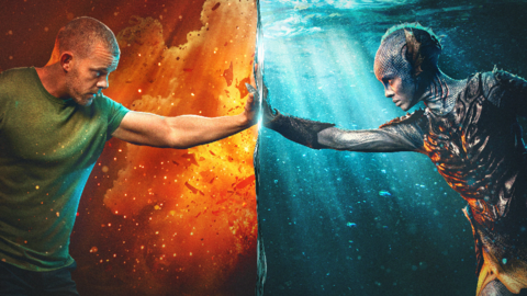 A composite image. On the left, Tovey is in character as Barclay and is stood in front of a orange and red fire themed background. He is wearing a green t-shirt and is stood with his arm reaching into the other side of the image with his hand touching Mbatha-Raw's hand. On the right, Mbatha-Raw is in character as Salt, and is stood in front of a blue ocean background. She is dressed as a mystical creature. 