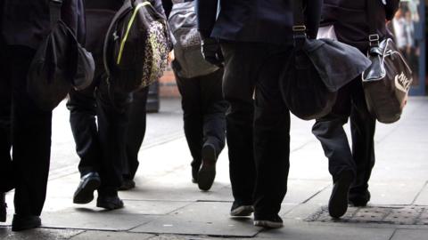 Image shows pupils walking to school