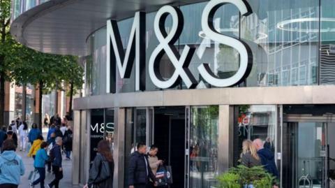 M&S store front with people walking outside