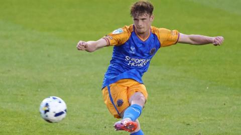 Tommy McDermott whips in a left-footed free-kick during a match for Shrewsbury