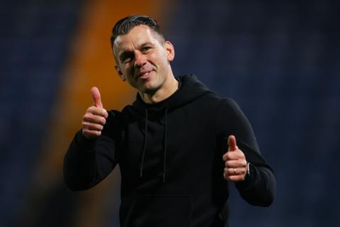 Matt Bloomfield gives a double thumbs up to supporters following their 5-0 win at Stockport County in League One