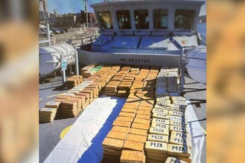 drugs in packages on a boat, they are in brown packages all on top of one another.