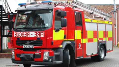 A parked red and yellow fire engine