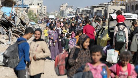 Palestinians flee the Jabalia area after complying with Israeli evacuation orders (22 October 2024)