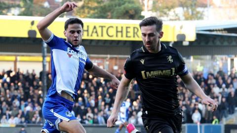 Robbie McKenzie of Gillingham (right) beats Fabrizio Cavegn of Bristol Rovers to the ball