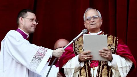 Pope reading from papers
