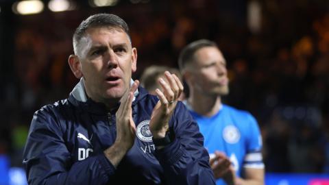 Dave Challinor applauds the Stockport County fans after their penalty shootout defeat by Leyton Orient