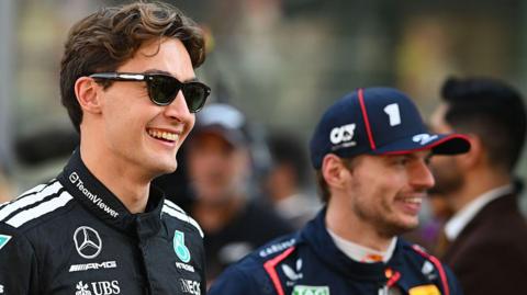 George Russell and Max Verstappen smiling prior to the F1 Grand Prix of Abu Dhabi in December 2025