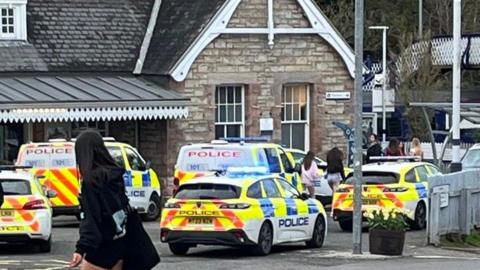 A number of police vehicles outside Aberdour Train Station.