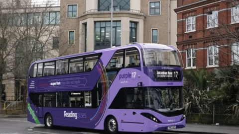 Purple Reading Bus stopped at a bus stop in Reading Town Centre