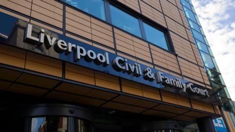 A tall brown building with the lettering "Liverpool Civil & Family Court"