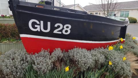 Boat with floral arrangements around it