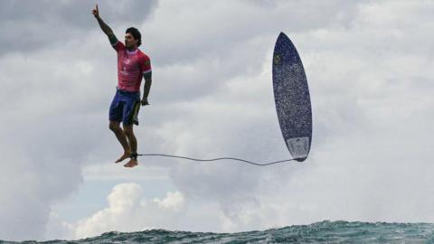 The third day of the surfing Olympic event in French Polynesia at Teahupo’o, Brazilian surfer Gabriel Medina gets the biggest wave of the competition and celebrates in a unique position by thanking God. July 29, 2024