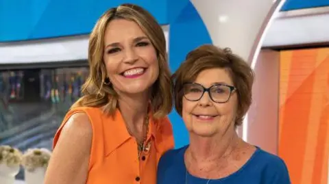 News anchor Savannah Guthrie stands with her mother Nancy Guthrie in NBC's Today studio. They are both smiling for the photo
