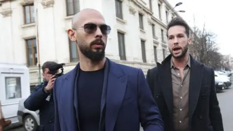 Andrew Tate (L) and his brother Tristan (R) leave the court building after an emergency appeal requesting the right to visit their mother, who has suffered a heart attack in UK, at the Bucharest Court of Appeal, in Bucharest, Romania, 22 December 2023