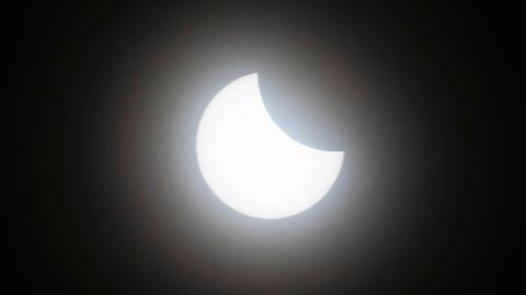 The sun is partially covered by the moon during a solar eclipse.