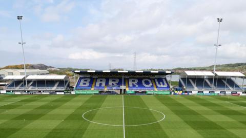 A high aerial view of Barrow's Holker Street ground with 'BARROW' in white on blue seats