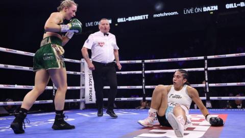 Rhiannon Dixon stands over her downed opponent