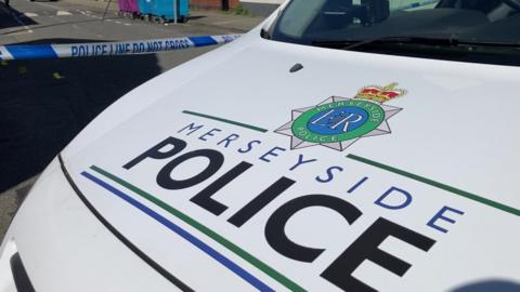 Close up of the bonnet of a Merseyside Police car with the logo across it.
