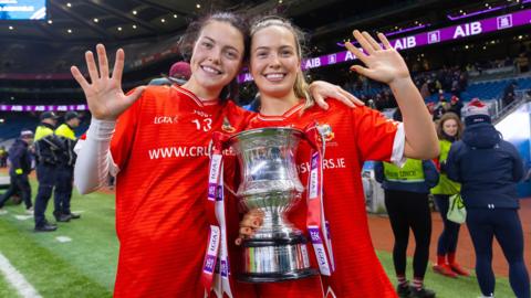 Eva Noone and Hannah Noone celebrate after the game 