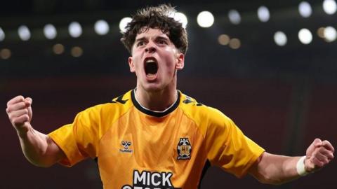 Cambridge United forward Glenn McConnell pumps his fists and screams in delight