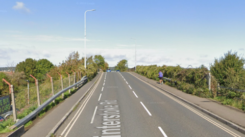 Google maps street view of Winterstoke Road in Weston-super-Mare. It is a straight, single carriageway. There is a pavement either side of the road.