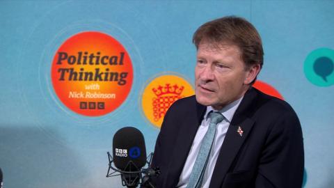 Richard Tice in a suit and tie speaking into a BBC Radio 4 microphone, with the 'Political Thinking with Nick Robinson' logo in the background."