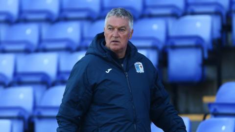 Rob Kelly looks on from the touchline in 2021 during his spell as Barrow boss.