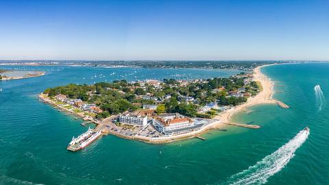 Aerial panorama view of Sandbanks Beach and Cubs Beach in Bournemouth, Poole and Dorset, England. Wide angle daytime.